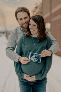 Couple enjoy snowy maternity session in downtown Houghton Michigan