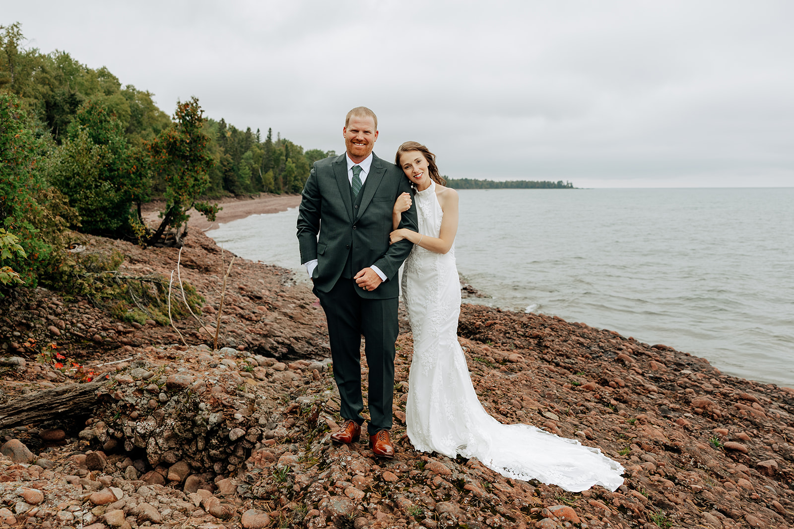 Elopement couple takes intimate portraits along rocky beach on Lake Superior during their Keweenaw elopement day