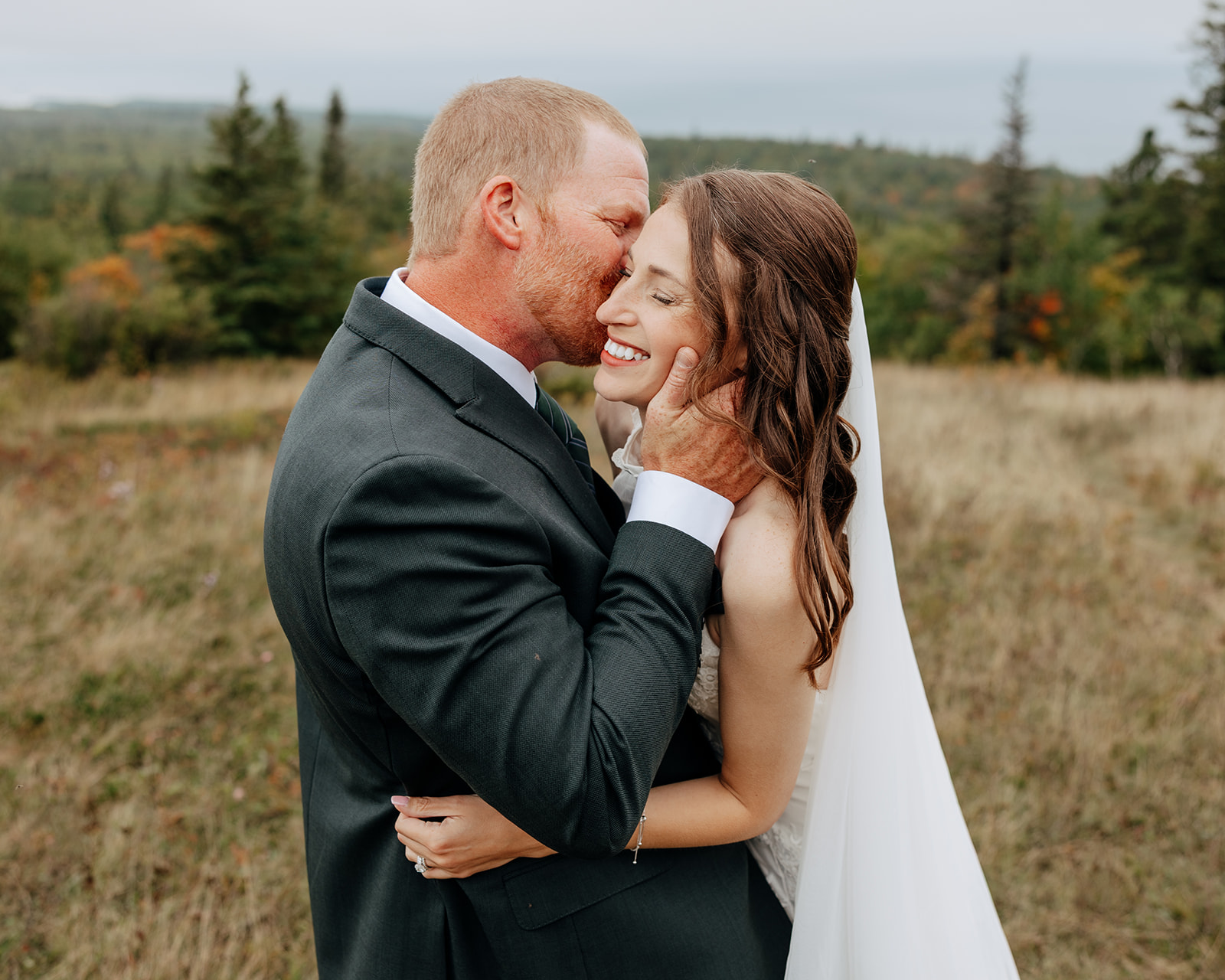 Bride and groom take fall elopement portraits on Brockway Mountain in Copper Harbor, Michigan during their Upper Peninsula elopement