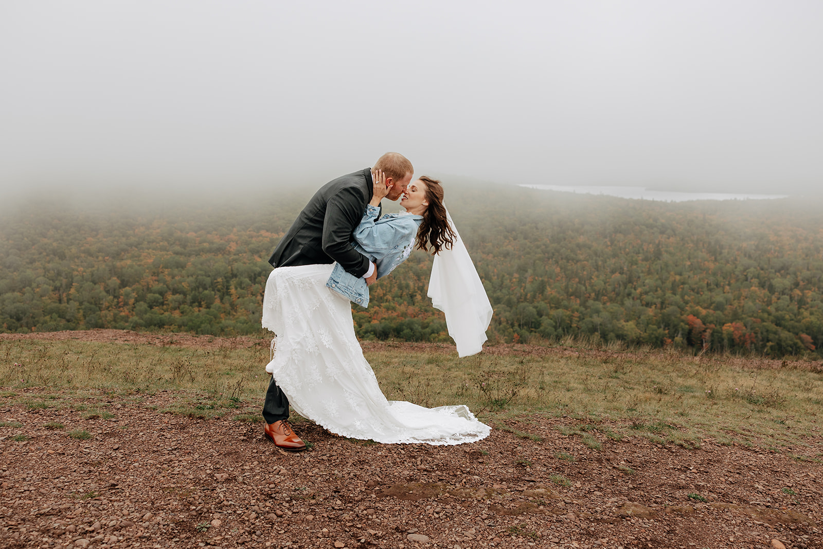 Bride and groom exchange a kiss on Brockway Mountain in Copper Harbor, Michigan during their Keweenaw Peninsula elopement
