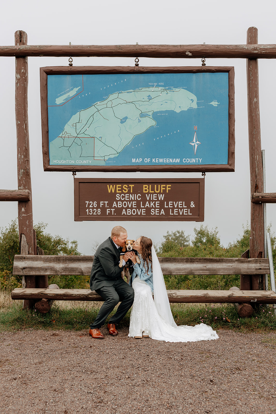 Bride and groom take fall elopement portraits on Brockway Mountain in Copper Harbor, Michigan during their Upper Peninsula elopement