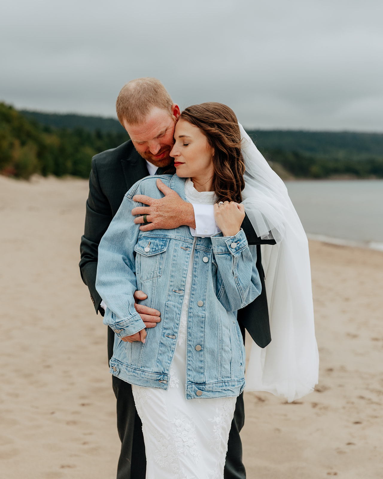 Bride and groom take wedding portraits at Great Sand Bay in Eagle Harbor, Michigan during their Upper Peninsula Michigan Elopement