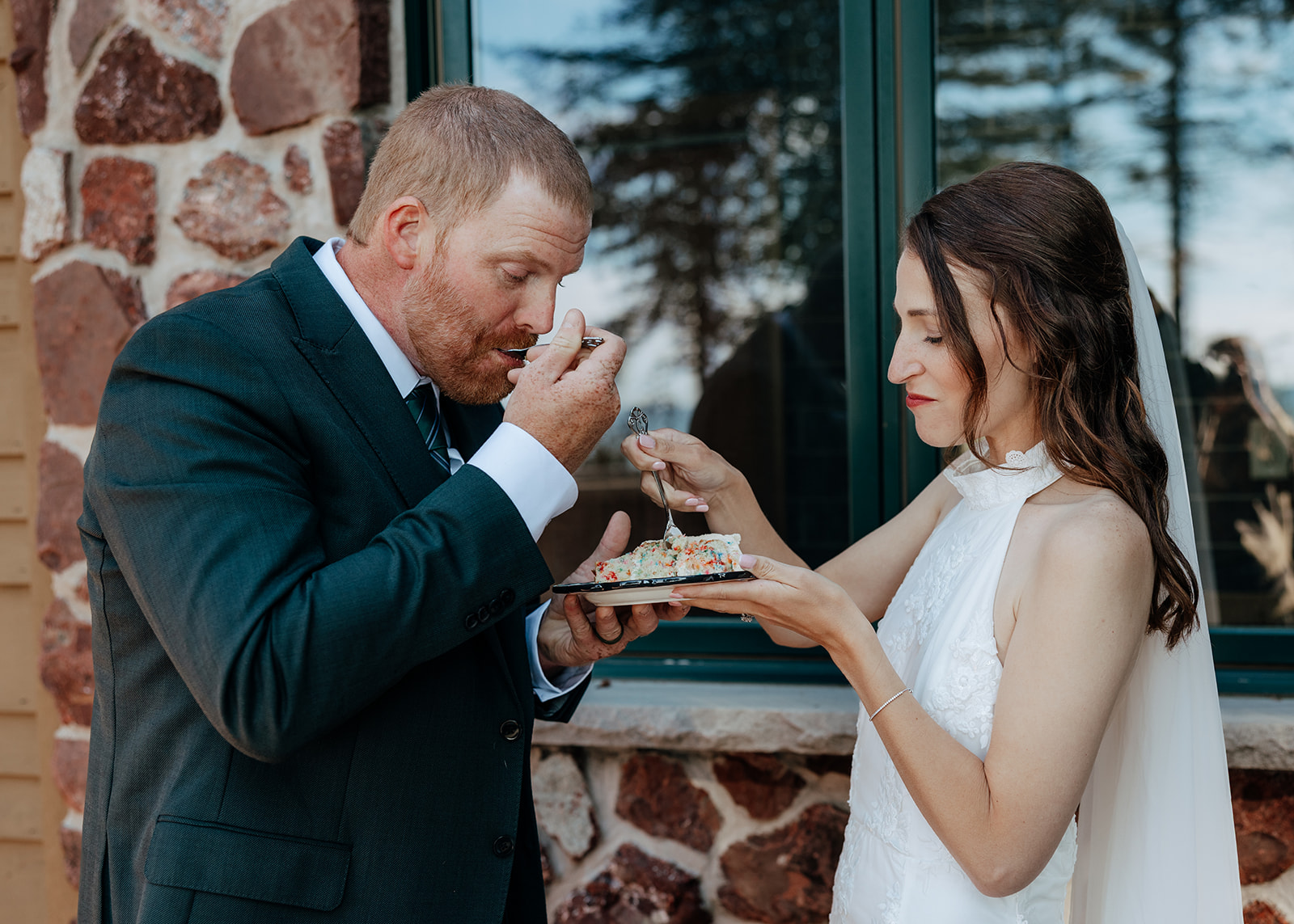 Bride and groom cut their cake at the Keweenaw Castle in Upper Peninsula of Michigan on their elopement day