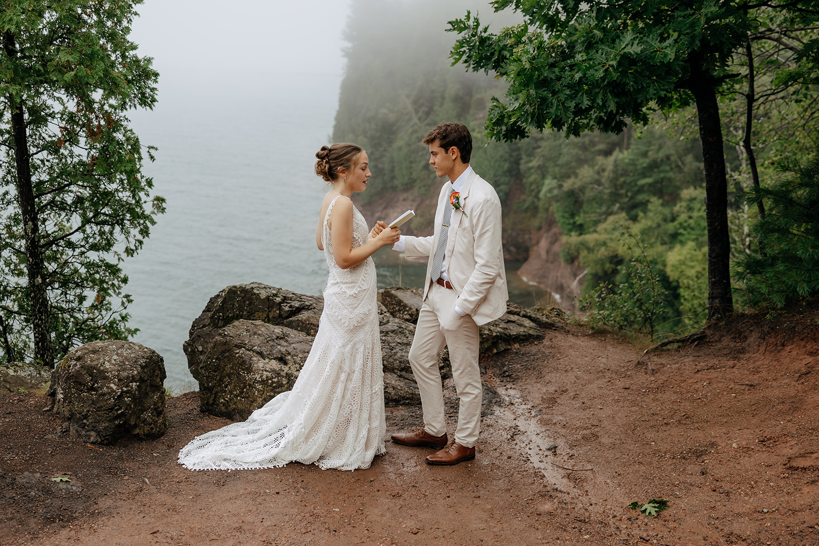 Couple share private vows on a foggy overlook on the shore of Lake Superior during their intimate outdoor wedding in Marquette Michigan