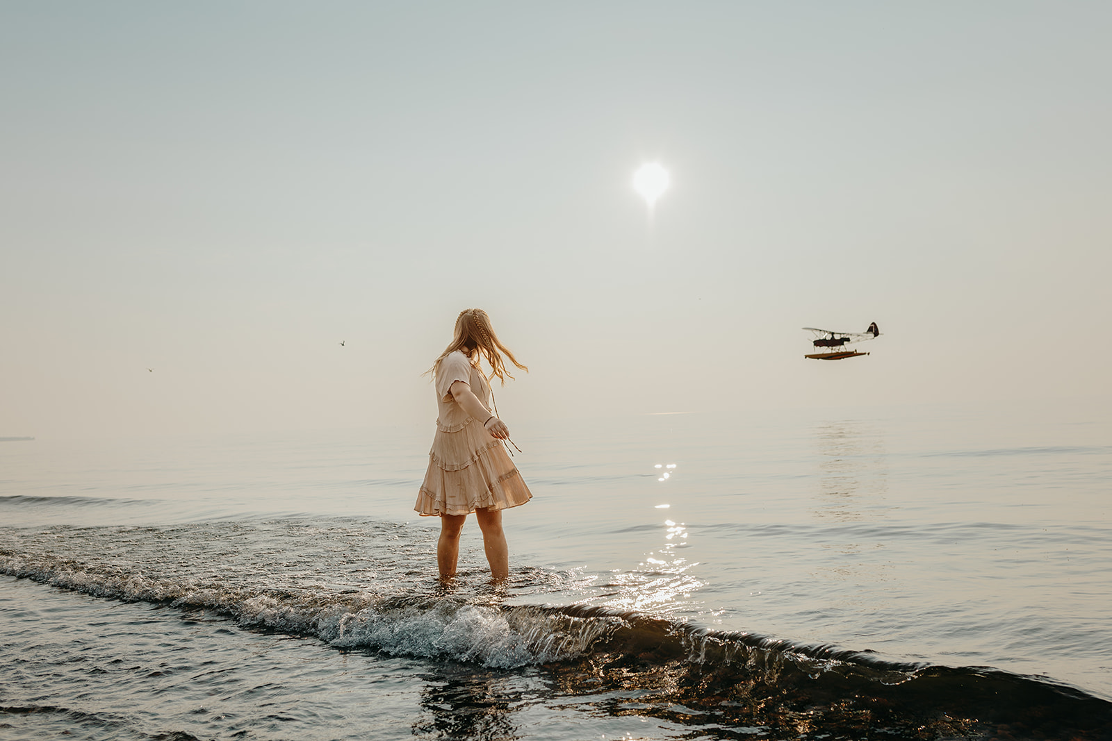 Abi takes a dip in Lake Superior duing her senior photos in Eagle River Michigan when a seaplane goes by